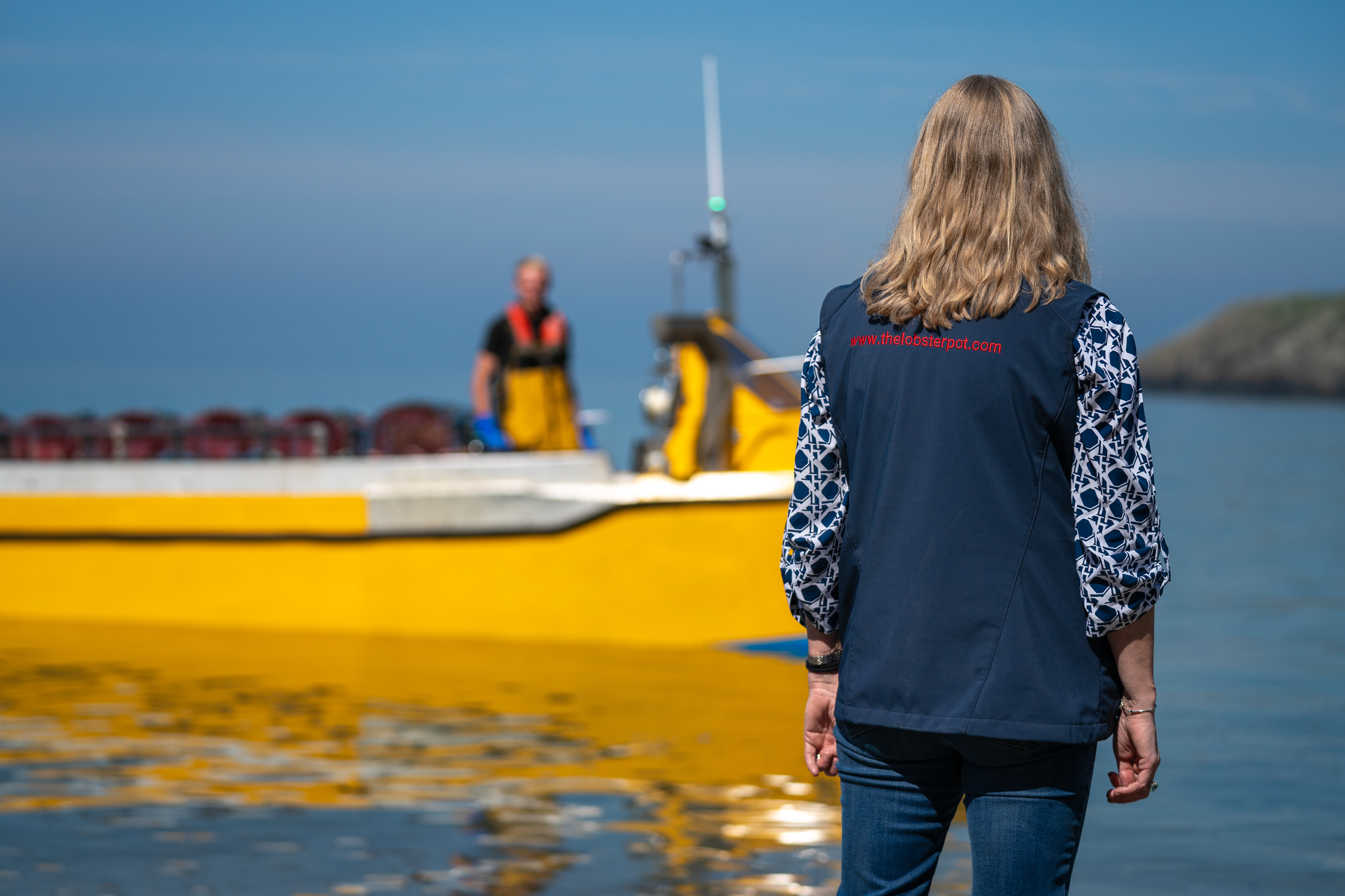 The family returning to The Lobster Pot, watching boats at Church Bay